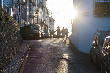 Personas caminando por la calle en contra luz