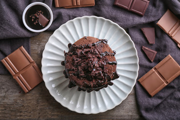 Plate with tasty chocolate pancakes on wooden table