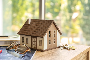 House model with key on table. Mortgage concept