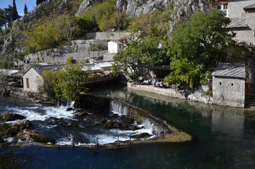 Fototapeta na wymiar Blagaj Tekija: Bosnia's Beautiful Monastery Under A Cliff. It situated next to the source of the river Buna. The Tekija was first founded during the height of the Ottoman empire.