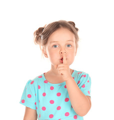 Cute little girl showing silence gesture on white background