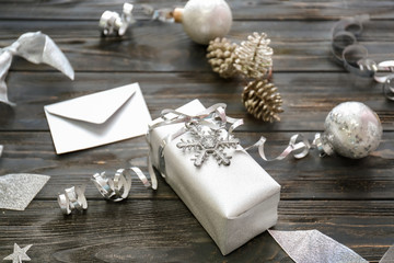 Beautiful Christmas gift box and decorations on wooden table