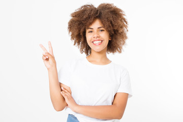 Afro curly hair. Happy young african american girl showing victory sign isolated on white background. Copy space. Template and blank summer t shirt.