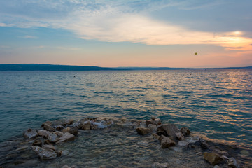 Beautiful sunset in Crikvenica, Croatia, with a parasailor on the left right of the frame.
