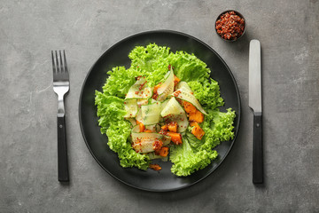 Plate with healthy fresh salad on grey background