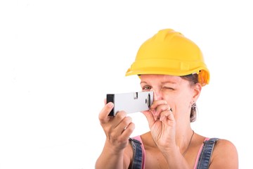 
Portrait of a young Craftsman woman with a spirit level - Woman construction worker isolated on white