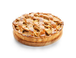Wooden board with delicious apple pie on white background