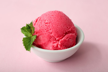 Bowl with delicious strawberry ice-cream on color background