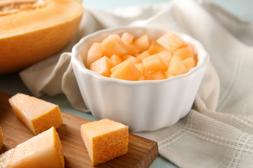 Bowl with pieces of ripe melon on table