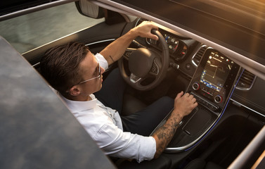 Close up of young man driving modern car