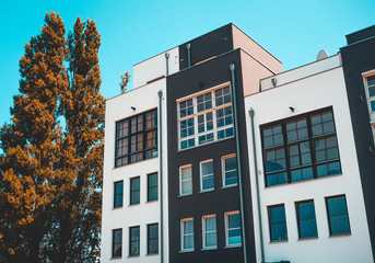 low angle view to modern townhouses with black and white facade