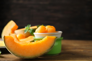 Cut ripe melon and balls on wooden table