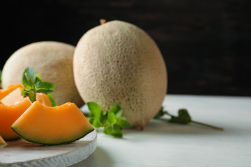 Pieces of tasty ripe melon on table