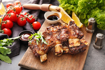 Delicious grilled ribs on wooden board