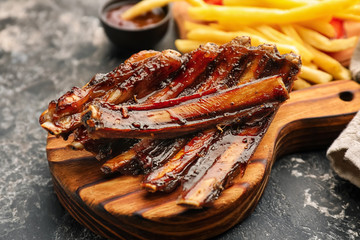 Delicious grilled ribs on wooden board