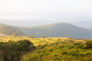 Fototapeta na wymiar The hilly terrain and bush in the Hluhluwe-imfolozi park, KZN, South Africa.