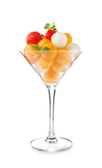 Glass with tasty melon balls on white background