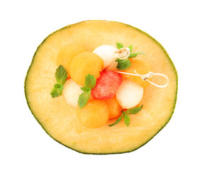 Tasty dessert in melon bowl on white background