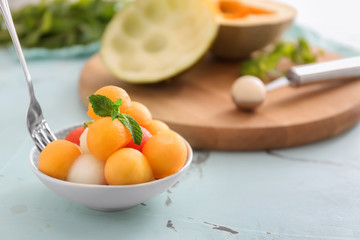 Bowl with tasty melon dessert on table