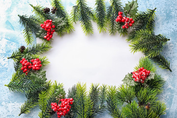Frame made of Christmas tree branches on light background