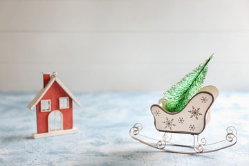 Christmas decorative sleigh and house on light table