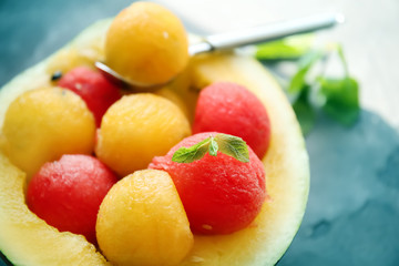 Half of watermelon with yellow and red balls, closeup