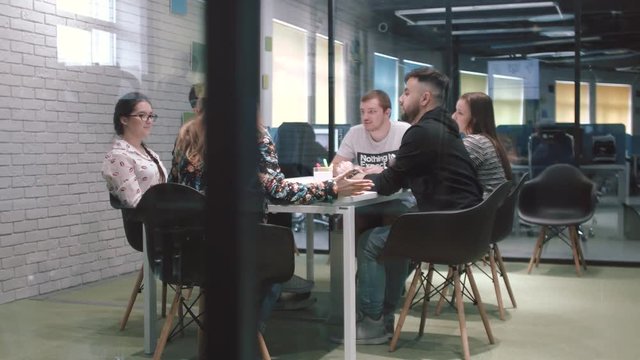 Team of young businessmen at a meeting. Discussing plans for the future.