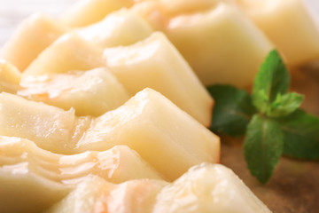 Sliced ripe melon with mint, closeup