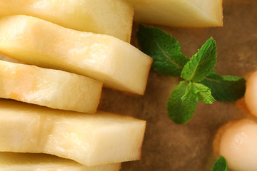 Sliced ripe melon with mint, closeup