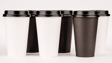 black paper cups on white background.