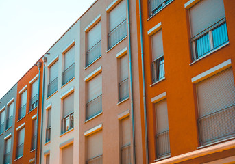 Obraz premium low angle view of modern townhouses with warm colored facades