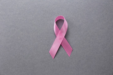 Pink ribbon on grey background. Breast cancer concept