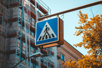 Fototapeta premium blue pedestrians traffic sign on a street light