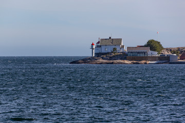 Old lighthouse on the small Stangholmen island with views of both the ocean, Norway