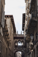 Fototapeta na wymiar A picturesque bridge-balcony in the Gothic Quarter