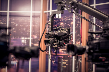 Camera in studio broadcasting news.