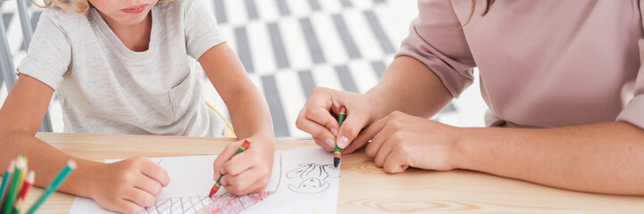 Close-up of kids drawing pictures during art classes at school © Photographee.eu