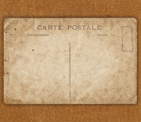 Vintage postcard on the brown leather background