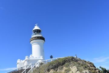 Simple white lighthouse blue skies