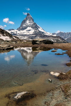 Scenic view of Matterhorn and its reflection on Riffelsee, an alpine lake of Riffelhorn in Zermatt, Switzerland.