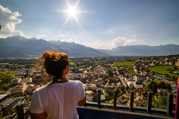 Female tourist admiring view of Vaduz, Liechtenstein. Vaduz is the capital of Liechtenstein and...