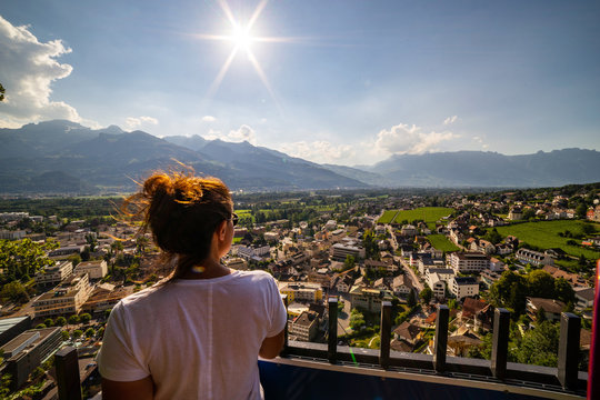 Female tourist admiring view of Vaduz, Liechtenstein. Vaduz is the capital of Liechtenstein and also the seat of the national parliament.