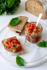 Rye bread toasts and glass jar with eggplant caviar. Vegetable appetizer or antipasti. Healthy food concept