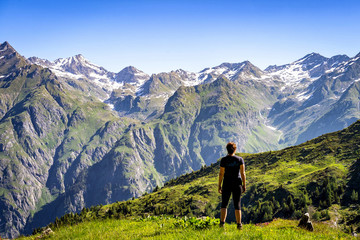 Female traveler admiring views of Swiss Alps in Val de Bagnes area, Switzerland.