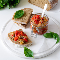 Rye bread toasts and glass jar with eggplant caviar. Vegetable appetizer or antipasti. Healthy food concept