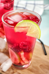 Glass of fresh raspberry cocktail on board