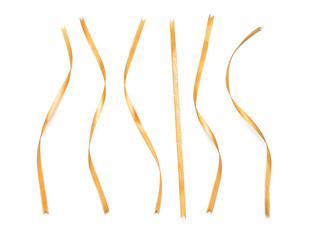 Curly golden ribbons on white background