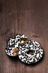 Traditional donuts on wooden background.  Tasty doughnuts with icing, copy space