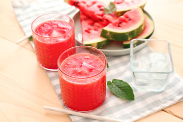 Glasses with fresh watermelon smoothie on wooden table