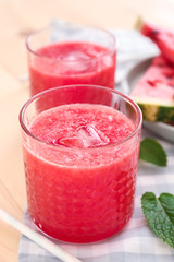 Glass with fresh watermelon smoothie on table